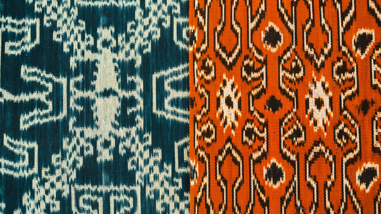 Two side-by-side close-up photographs of traditional Islamic geometric textile patterns: the left fabric features a teal/dark blue base with cream-colored geometric medallion designs, and the right fabric displays an orange base with cream and dark geometric interlocking patterns typical of Islamic decorative arts.
